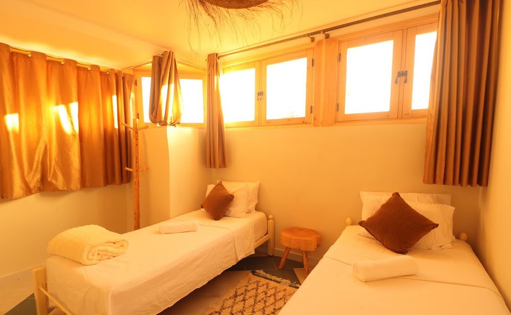 Twin room with two single beds and warm light