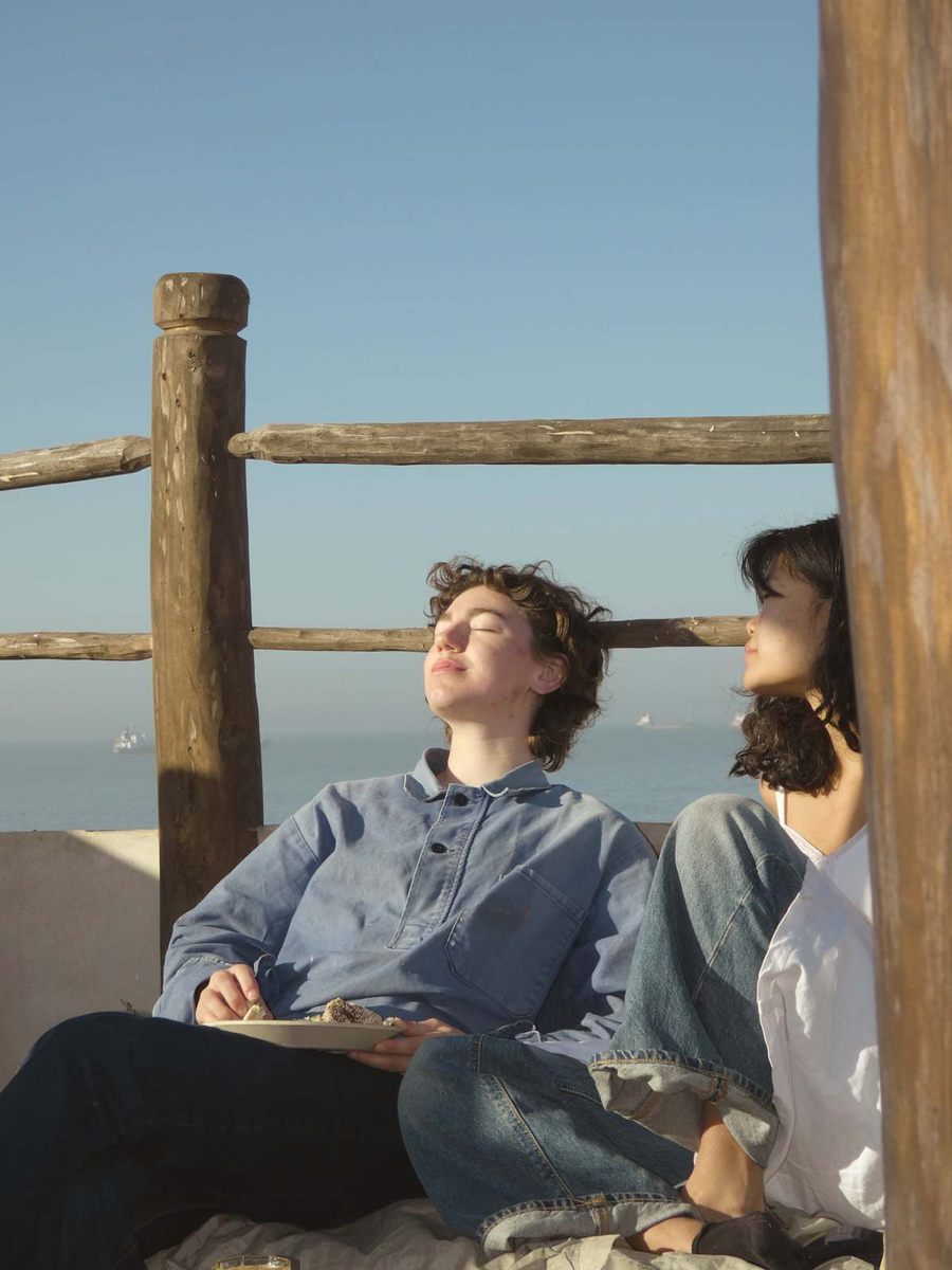 Guest reading on the rooftop corner seat in the sun